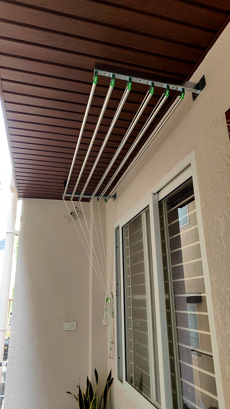Wall mounted pull and dry hanger with six steel rods on a balcony